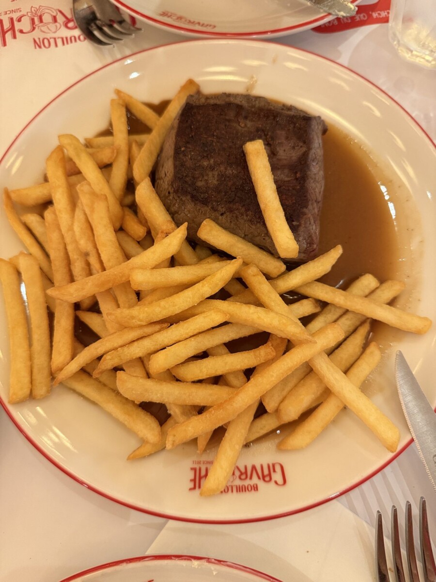 Wagyu petit tender steak frites with jus and peppercorn sauce, top-down view
