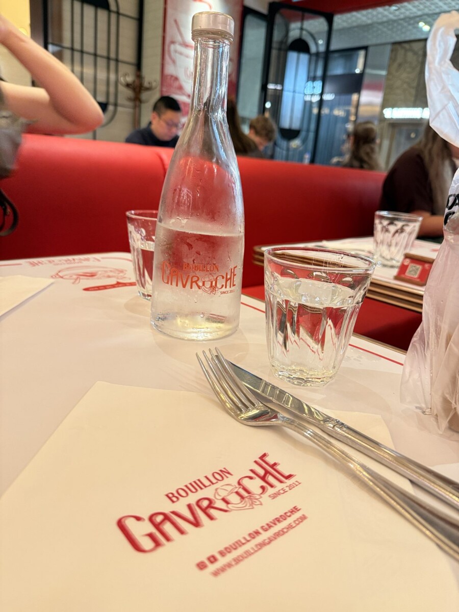 Branded free-flow water bottle and table setting at Bouillon Gavroche