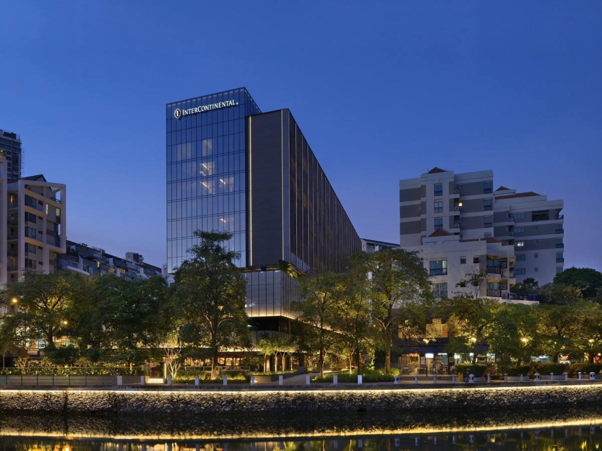 InterContinental Singapore Robertson Quay hotel exterior along the Singapore River at dusk