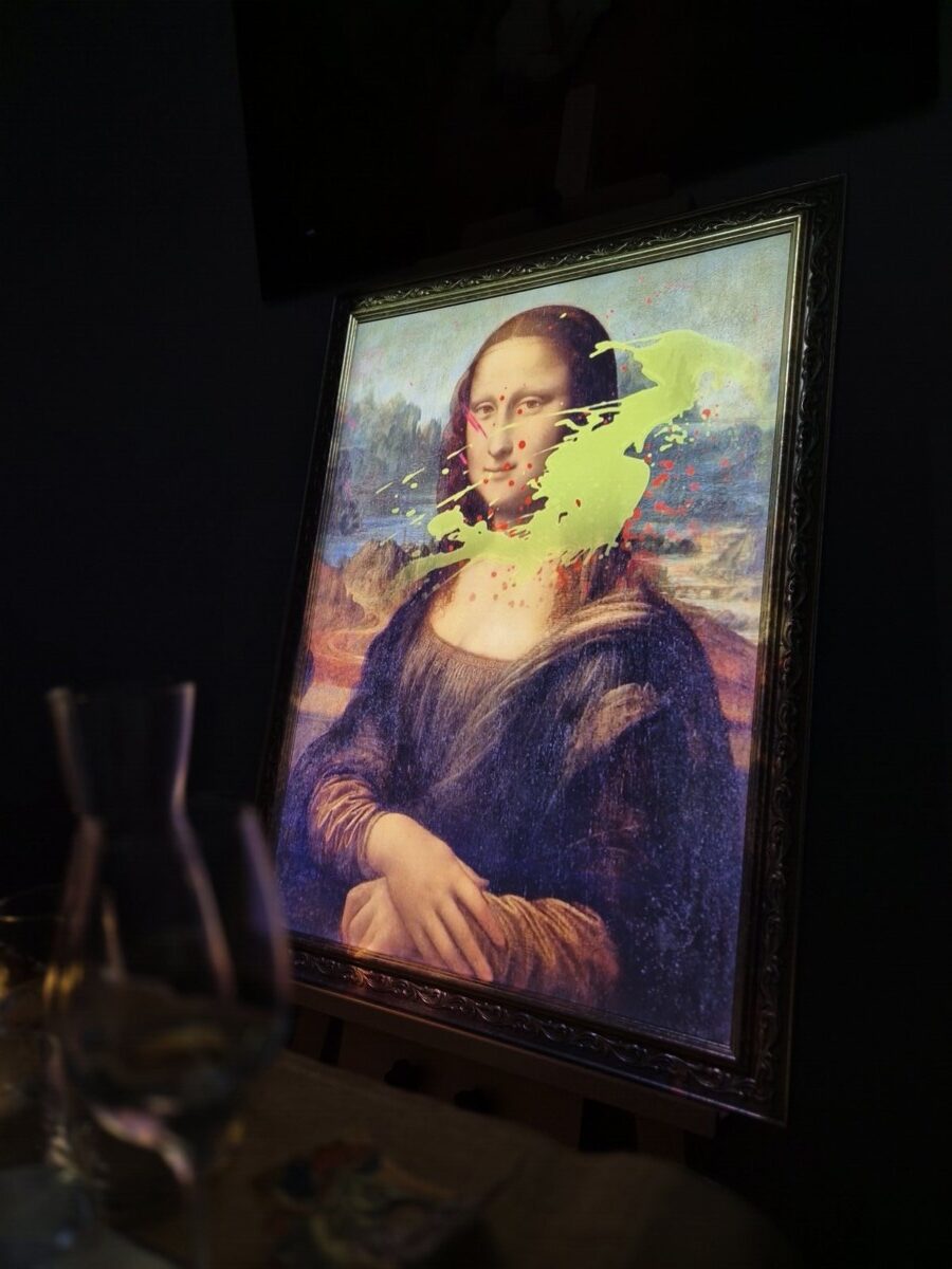 Mona Lisa canvas splashed with paint during the 7 Paintings dinner show at Conrad Singapore Marina Bay