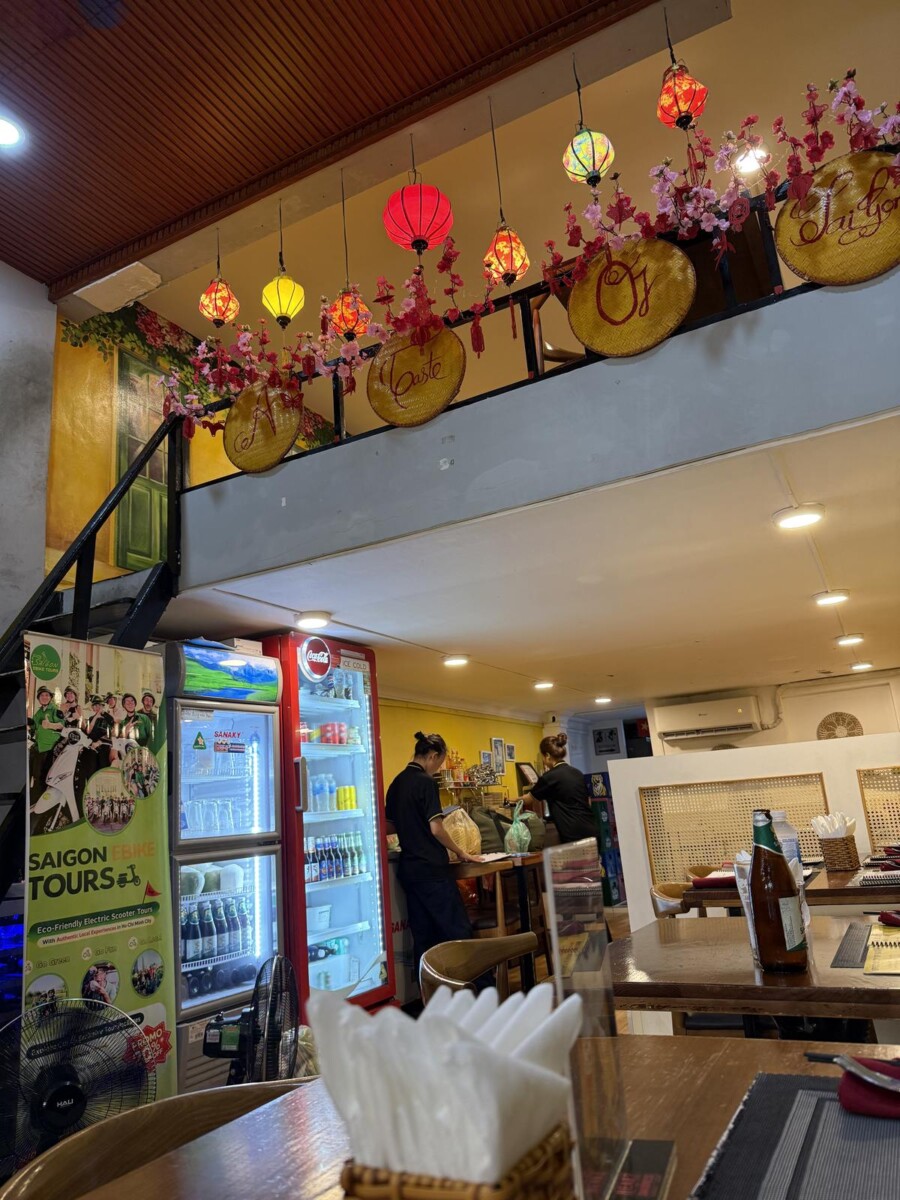 Interior of A Taste of Saigon with lanterns and woven hats along the mezzanine railing