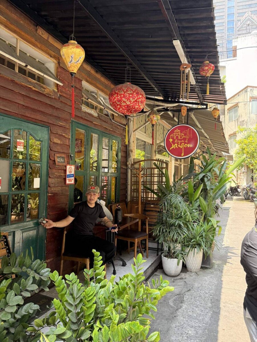 A Taste of Saigon shopfront at 42/6b with wooden facade, green doors, lanterns and a red sign
