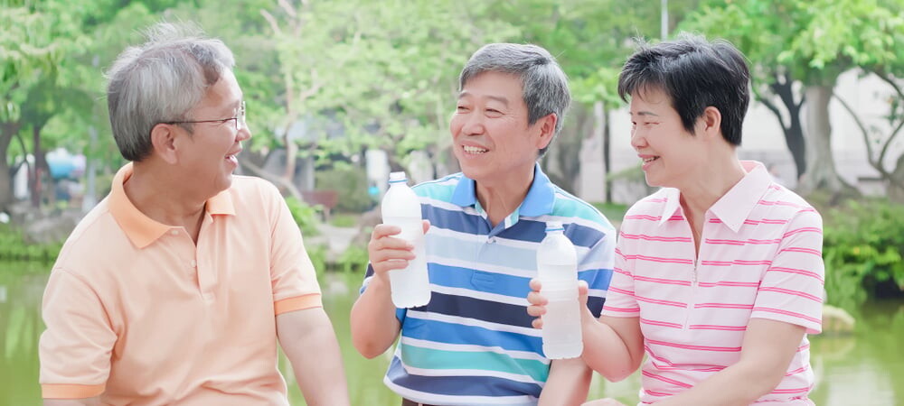 Three seniors chatting outdoors in a park