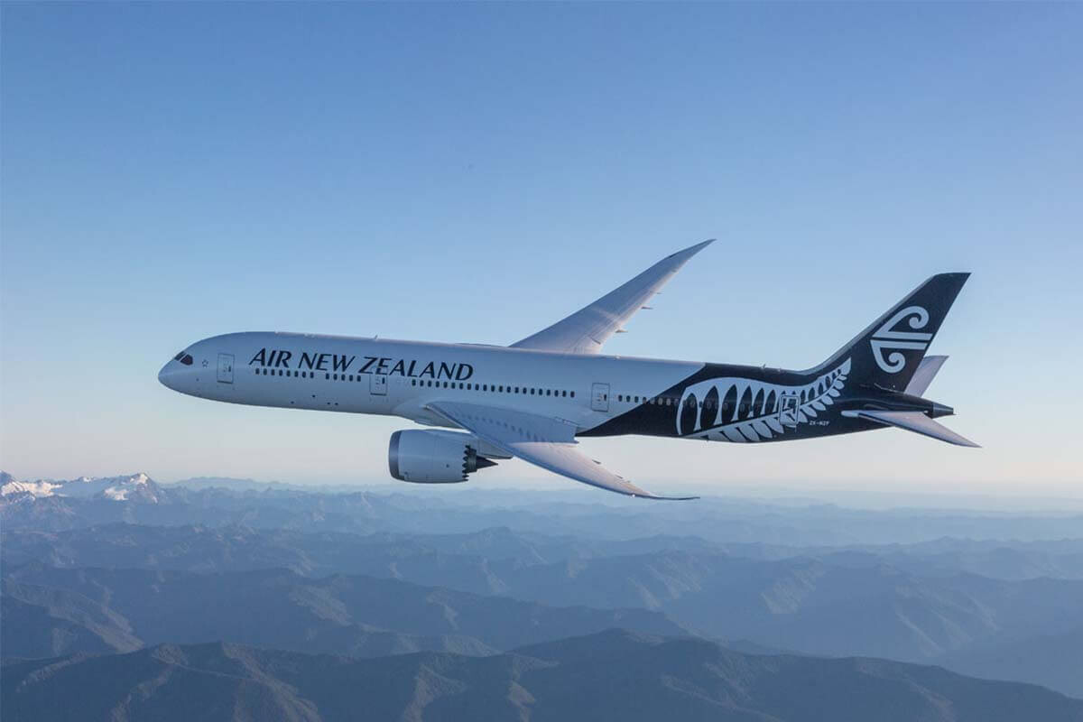 Air New Zealand Boeing 787-9 Dreamliner in flight over mountains