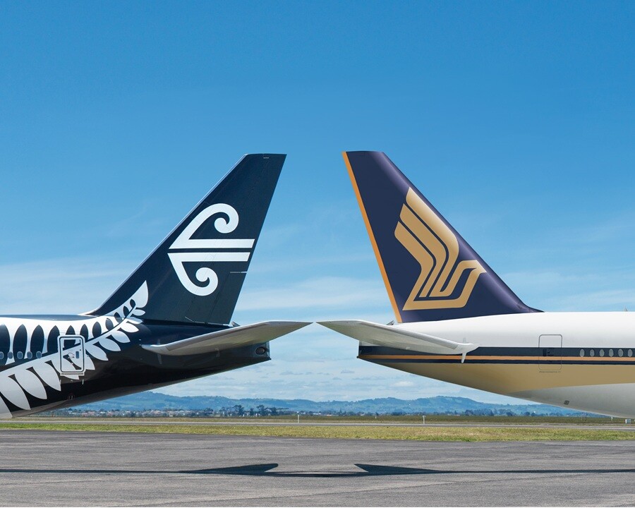 Air New Zealand and Singapore Airlines aircraft tails side by side on the apron
