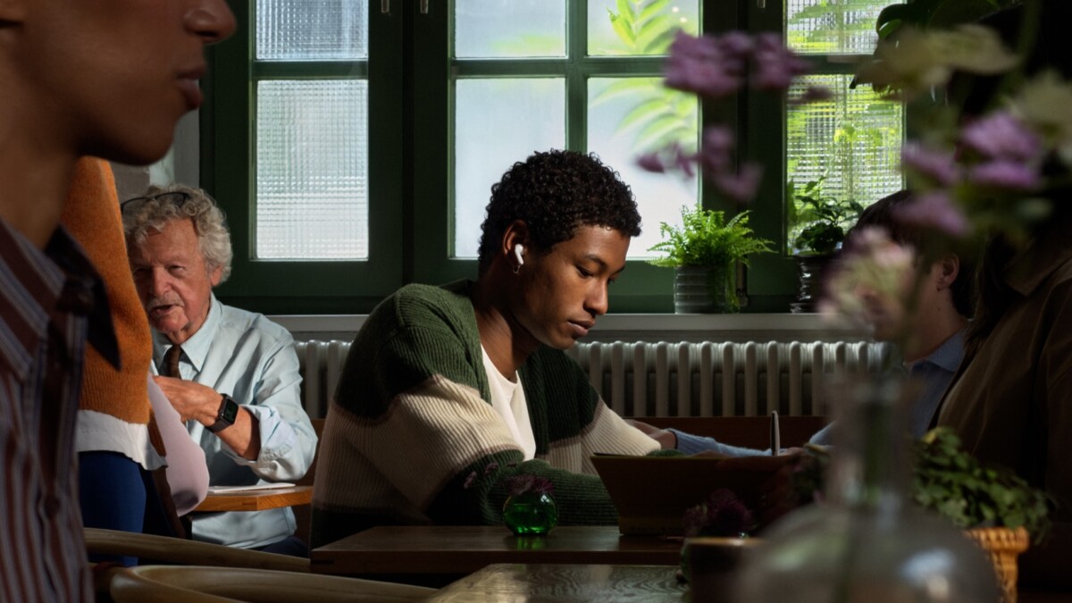 Person wearing AirPods 5 with open-ear design