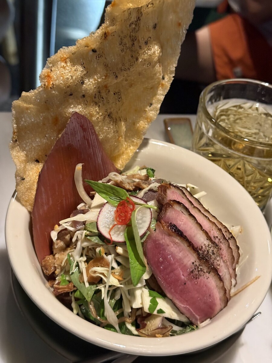 Duck and Banana Blossom Salad at Anan Saigon with sliced duck breast, shredded cabbage, herbs, peanuts and a crispy rice paper cracker