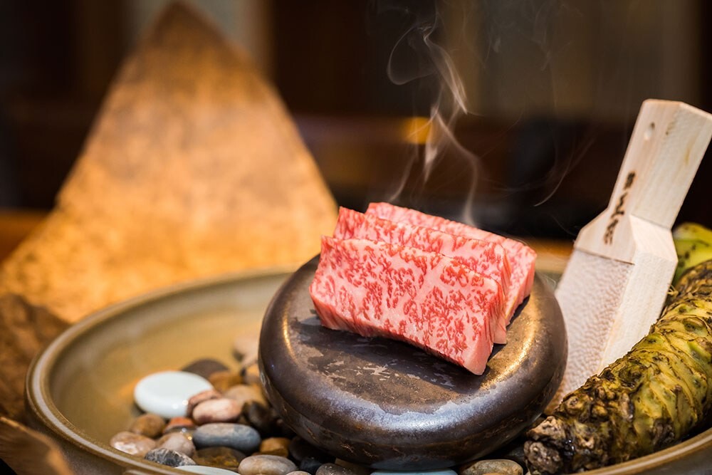 Steak finishing on a hot stone at Bari Bari Grand teppan table