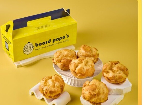 Beard Papa's signature custard cream puffs with a yellow takeaway box