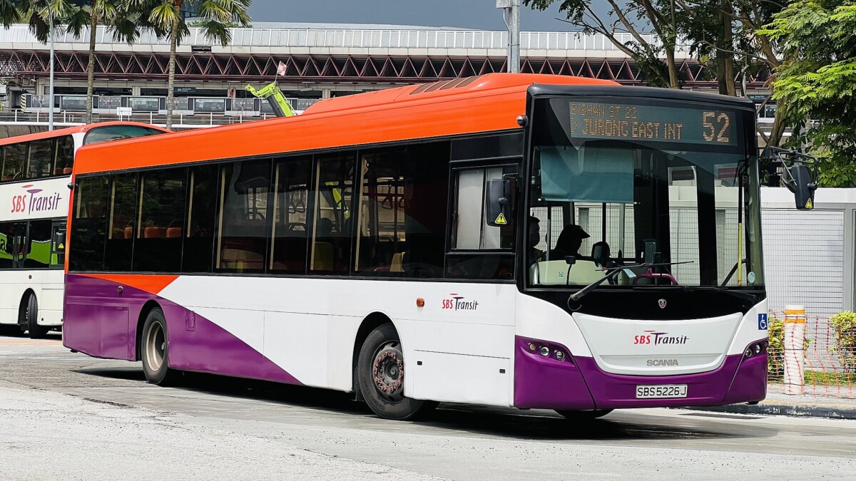 An SBS Transit Scania bus on service 52 at Jurong East integrated transport hub, showing the orange, white and purple livery