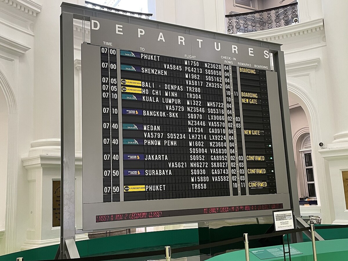 Changi Airport departure board showing Scoot and other flights from Singapore