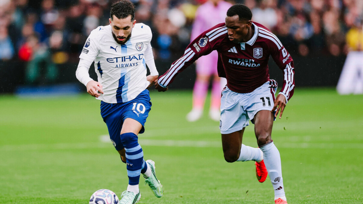 Rayan Cherki on the ball as an Aston Villa player chases