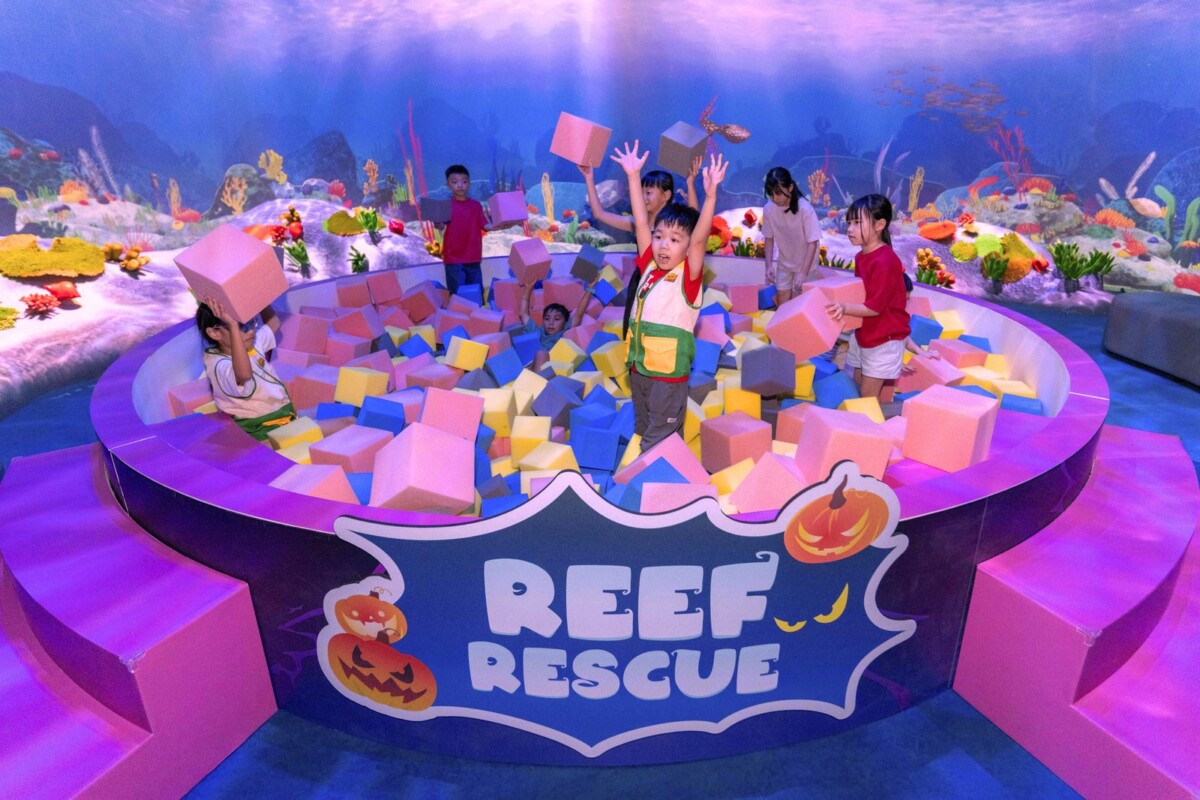 Children playing the Reef Rescue challenge at Curiosity Cove during The Mischief Within Halloween event