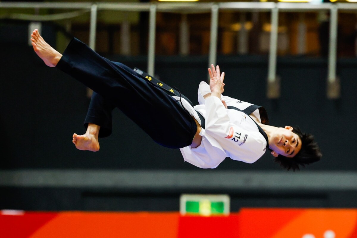 Darren Yap mid-air during a freestyle poomsae routine at the Aichi-Nagoya 2026 Asian Games