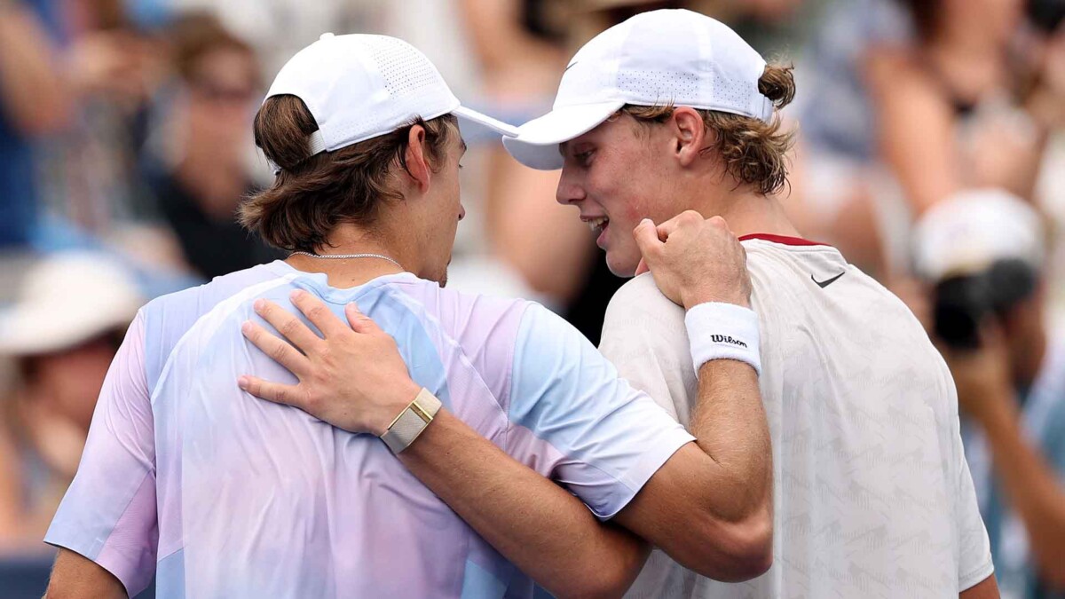 Alex de Minaur and Australian tennis legend Lleyton Hewitt share a warm embrace after de Minaur's victory in Washington