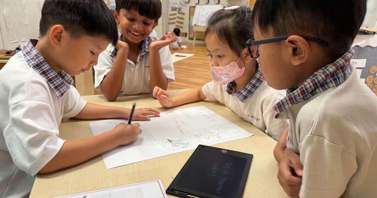 E-Bridge Pre-School children working on an online safety activity at a table