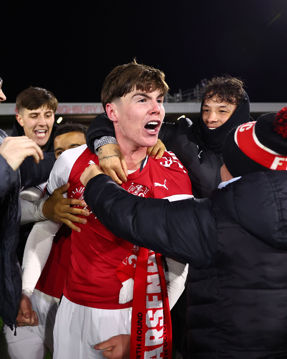 Fleetwood Town player celebrates with fans after the Carabao Cup shoot-out win over Arsenal