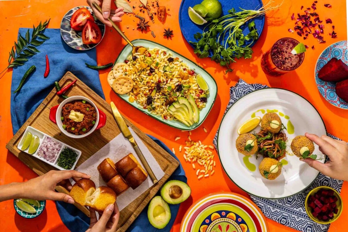 Modern Indian dishes on an orange table at Gully Restaurant & Garden