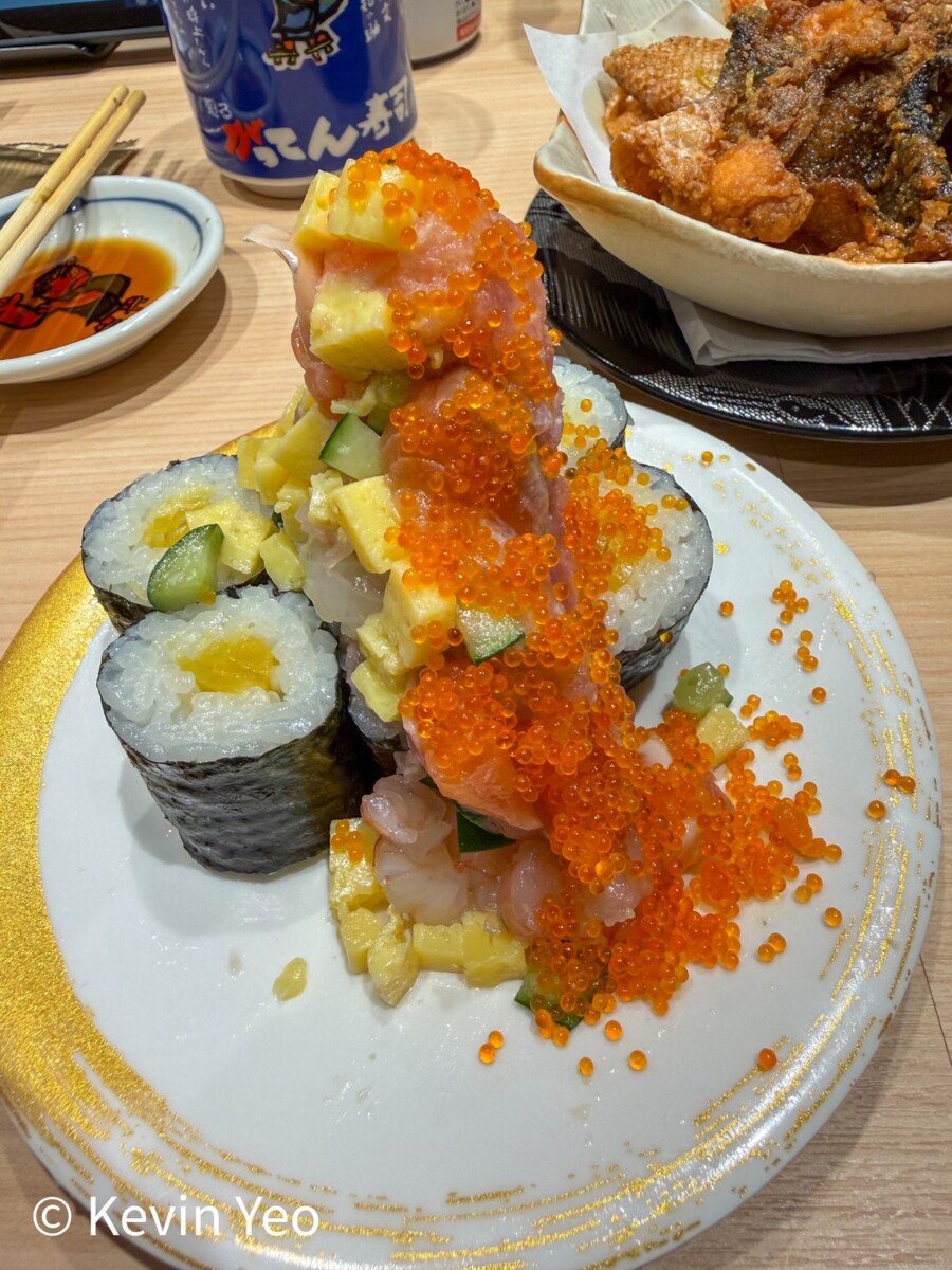 Overflowing sushi rolls piled high with fresh toppings