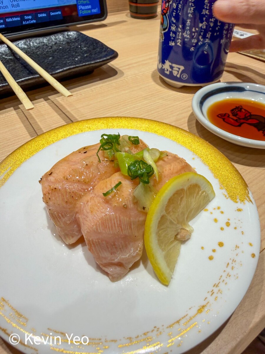 Seared salmon sushi topped with chopped green onion