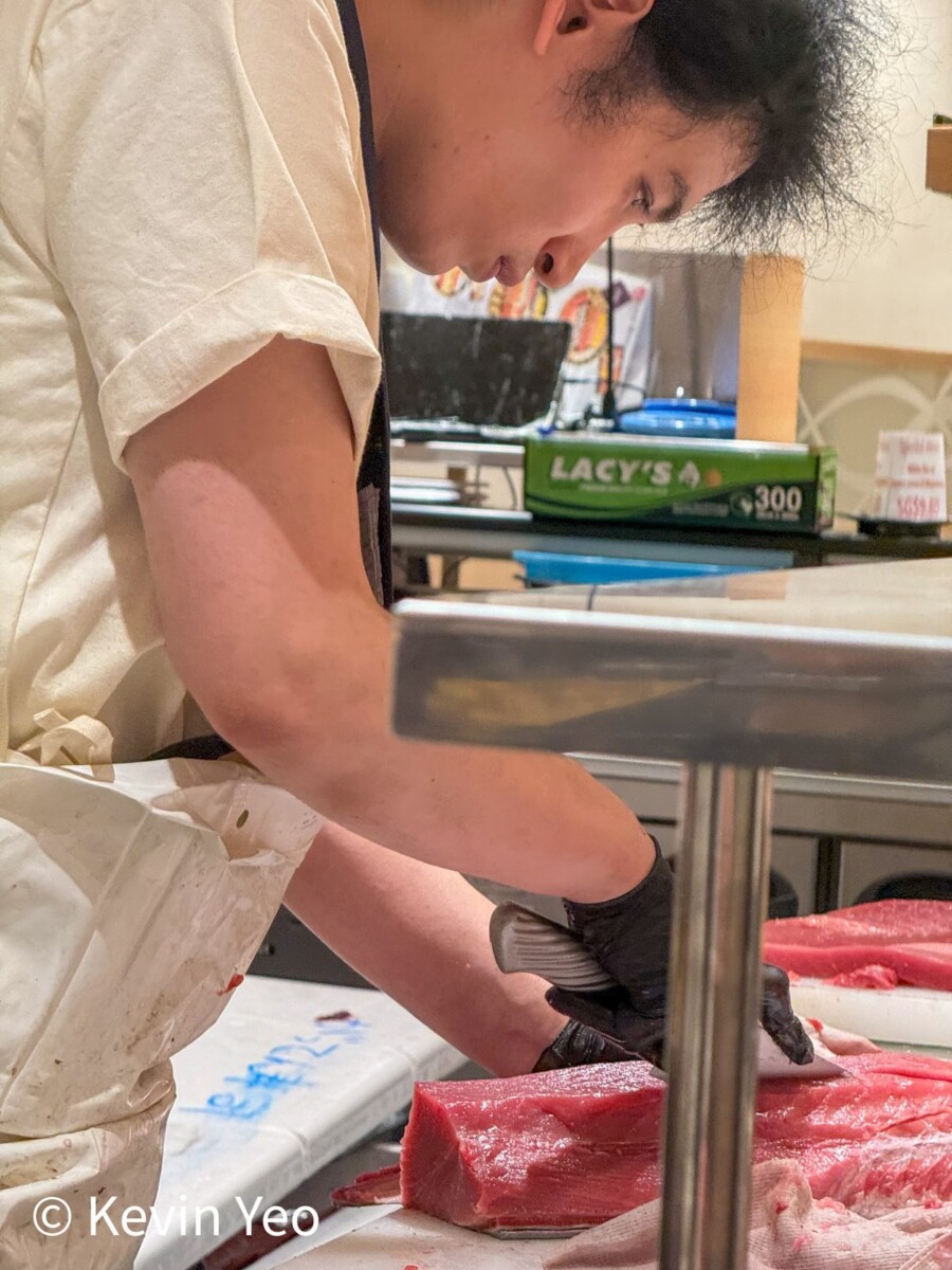 Fresh tuna being sliced at Gatten Sushi kitchen