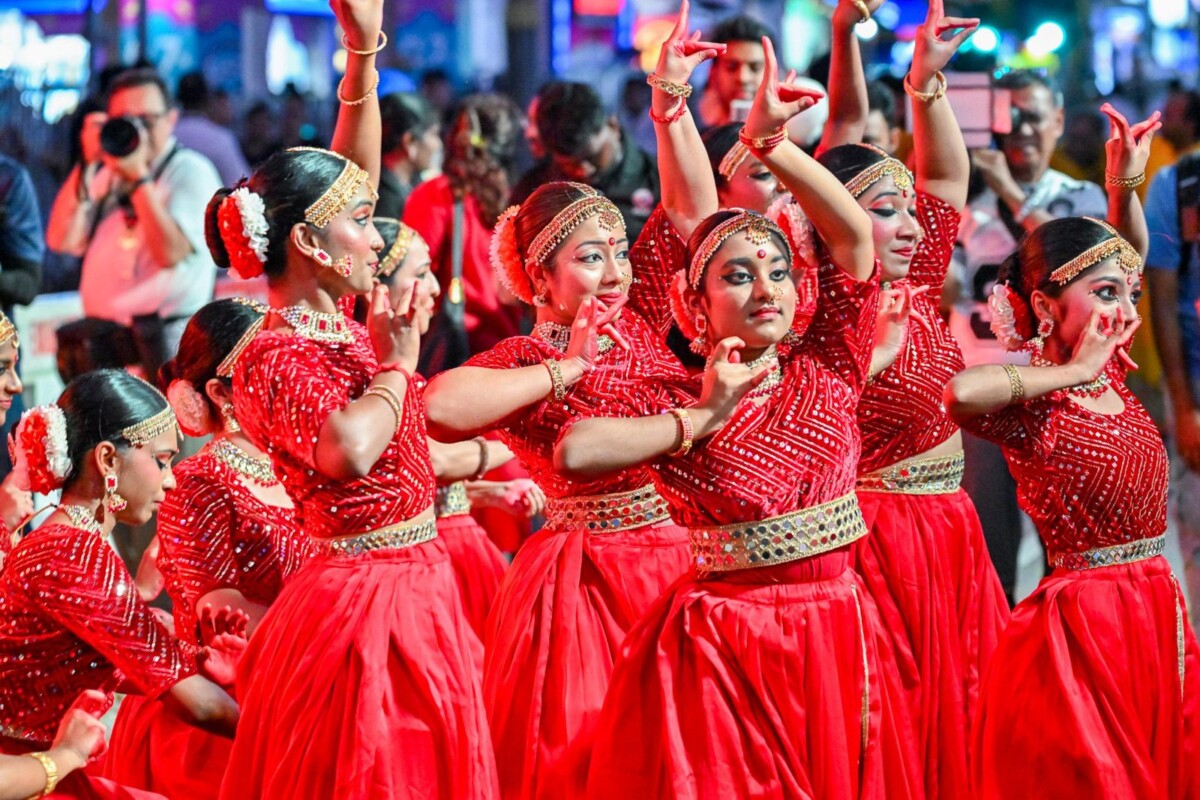 Dancers in red costumes performing during the Deepavali Open House at the Indian Heritage Centre