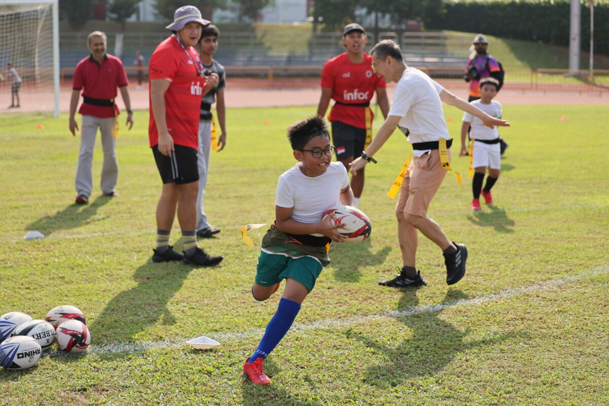Children playing tag rugby at a GetActive! Singapore 2026 carnival
