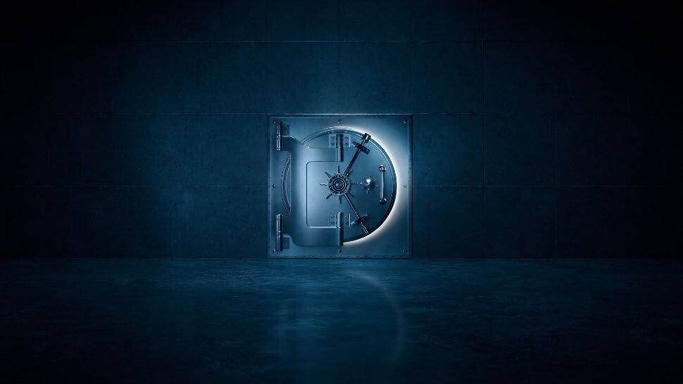 The Secret Vault key visual showing a lit vault door in a dark concrete room