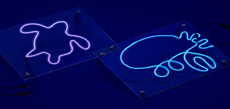 Visitors crafting glowing neon marine artwork at Singapore Oceanarium