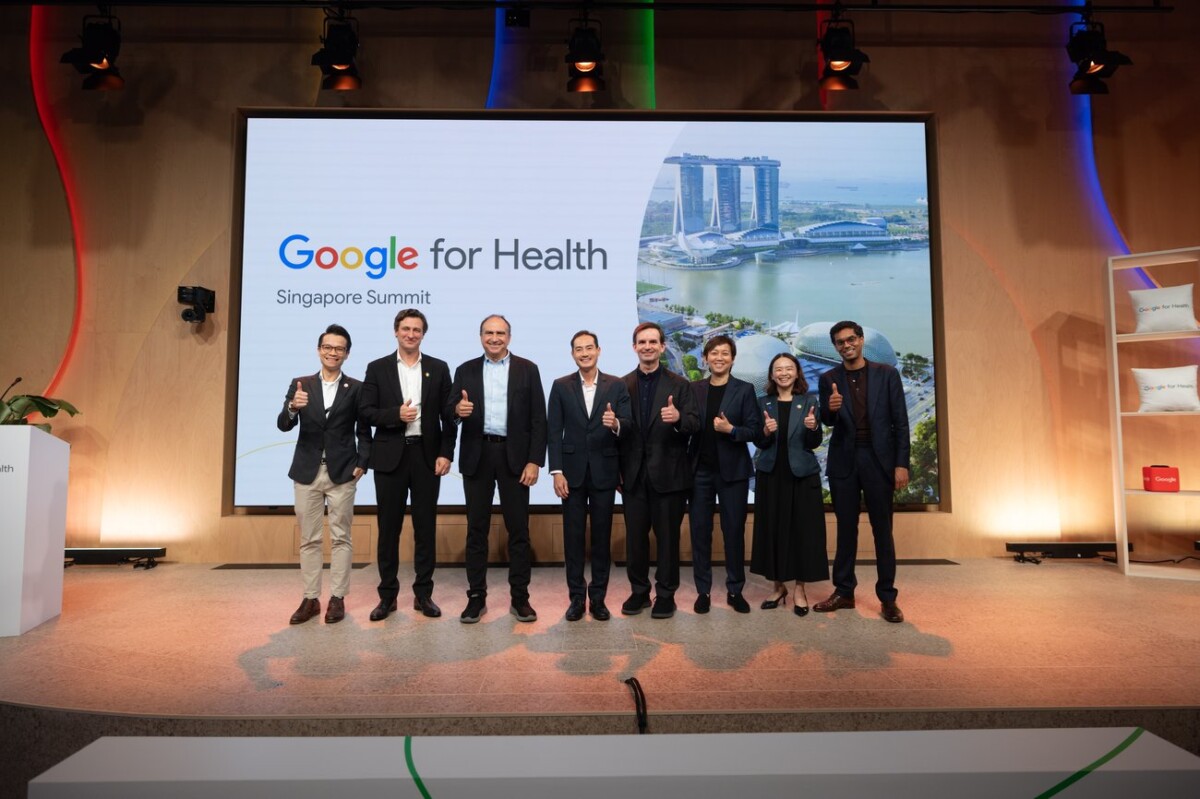 Speakers on stage at the Google for Health Singapore Summit in front of a Marina Bay screen