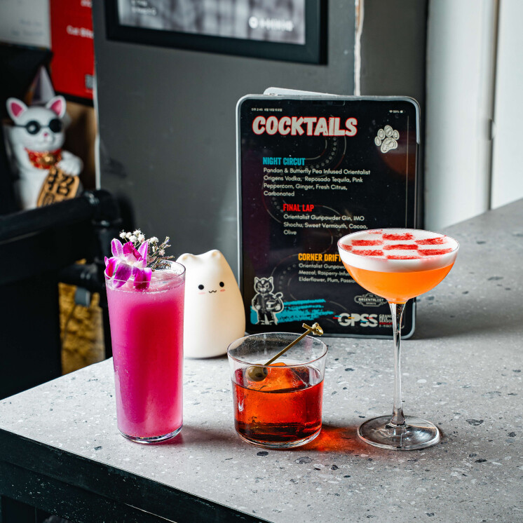 Cat Tracks race-week cocktails beside a GPSS cocktail menu at Cat Bite Club