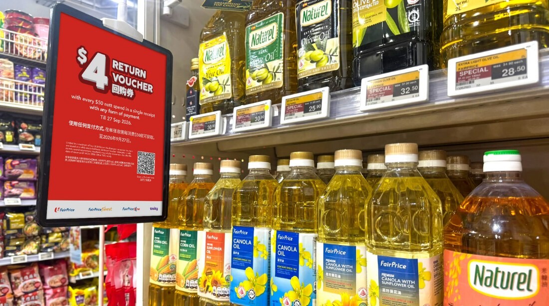 FairPrice $4 return voucher sign on a supermarket shelf