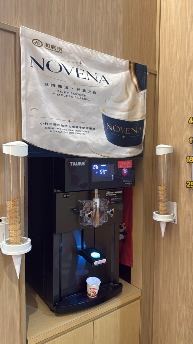 Haidilao Novena soft-serve station banner stating condiments fee includes Hokkaido ice cream