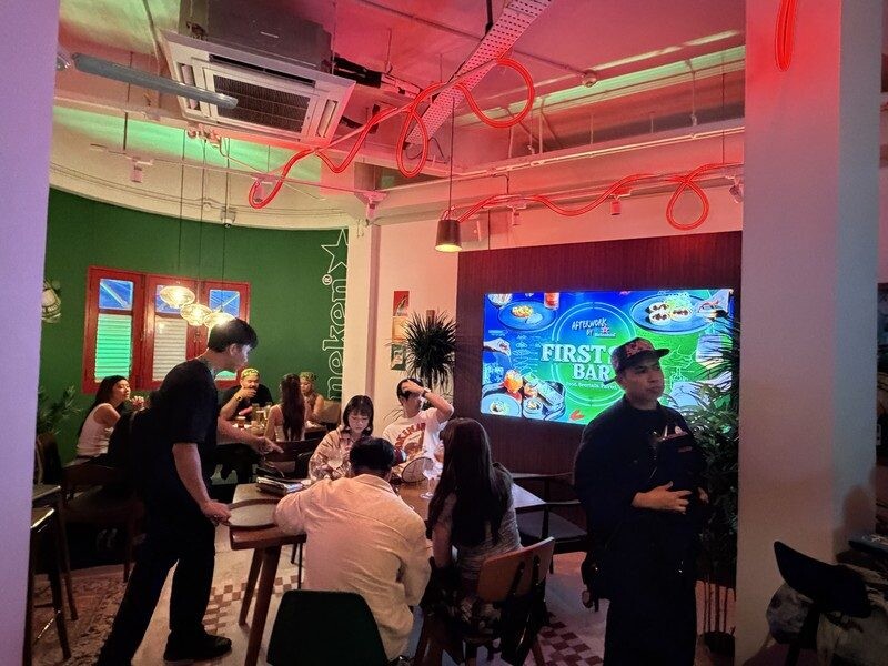 First Sip Bar floor with red neon ceiling and Pure Malt pairings screen at Heineken First Sip House