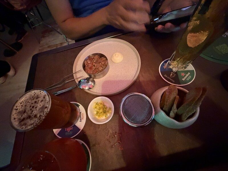 Tuna tartare bar bite with Pure Malt powder and crostini paired with a beertail at First Sip Bar