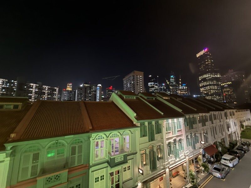 Rooftop view of Keong Saik shophouses and Singapore CBD skyline at night from Heineken First Sip House