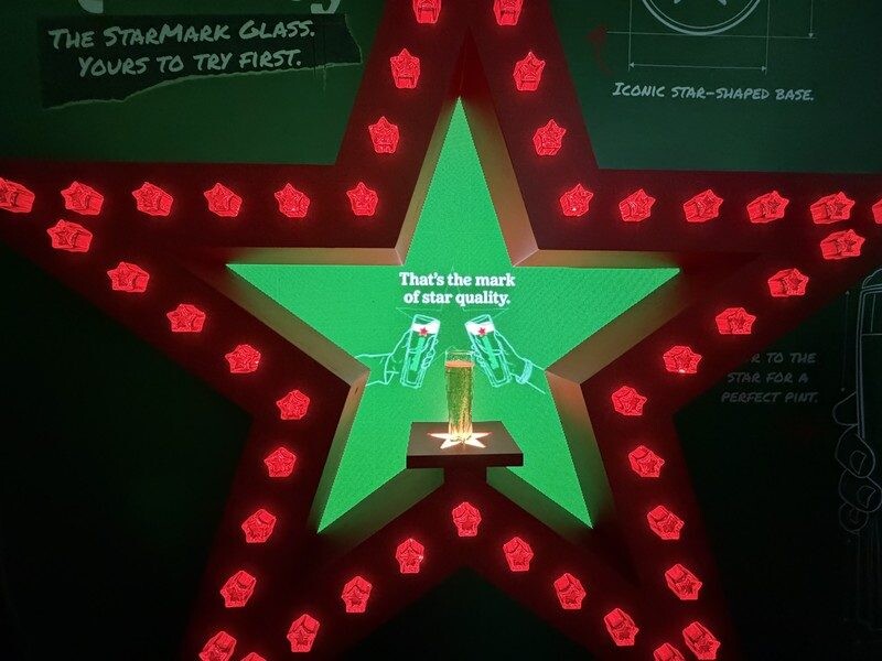 StarMark Glass display in a red star-shaped frame at Heineken First Sip House