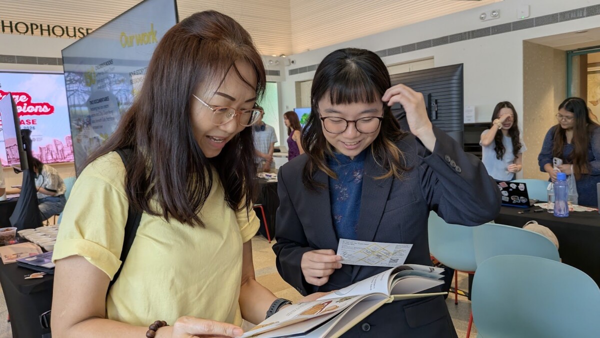 Visitors browse a student heritage project at the showcase. Image: GLOO Public Relations / TF-NUS Heritage Champions