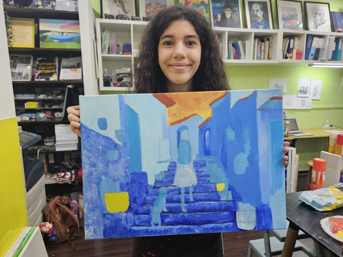 Artgrain artist Zaina Taleb, 11, holding her artwork