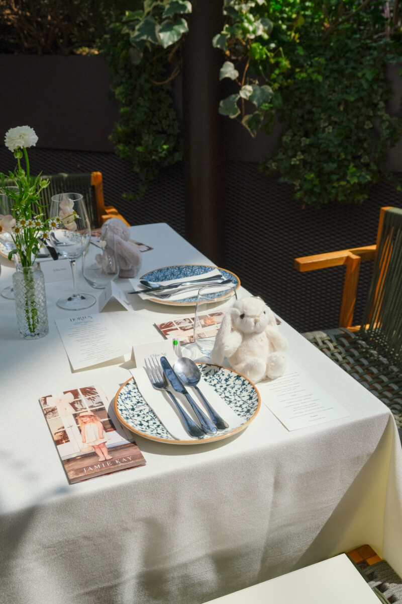 Hortus restaurant table setting with branded menu card and floral arrangement