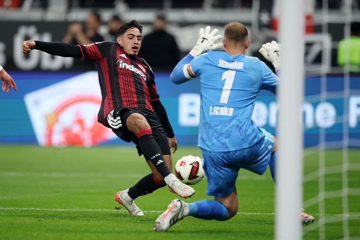 Fares Chaibi shoots as Cologne goalkeeper Marvin Schwabe blocks at Deutsche Bank Park in the first half