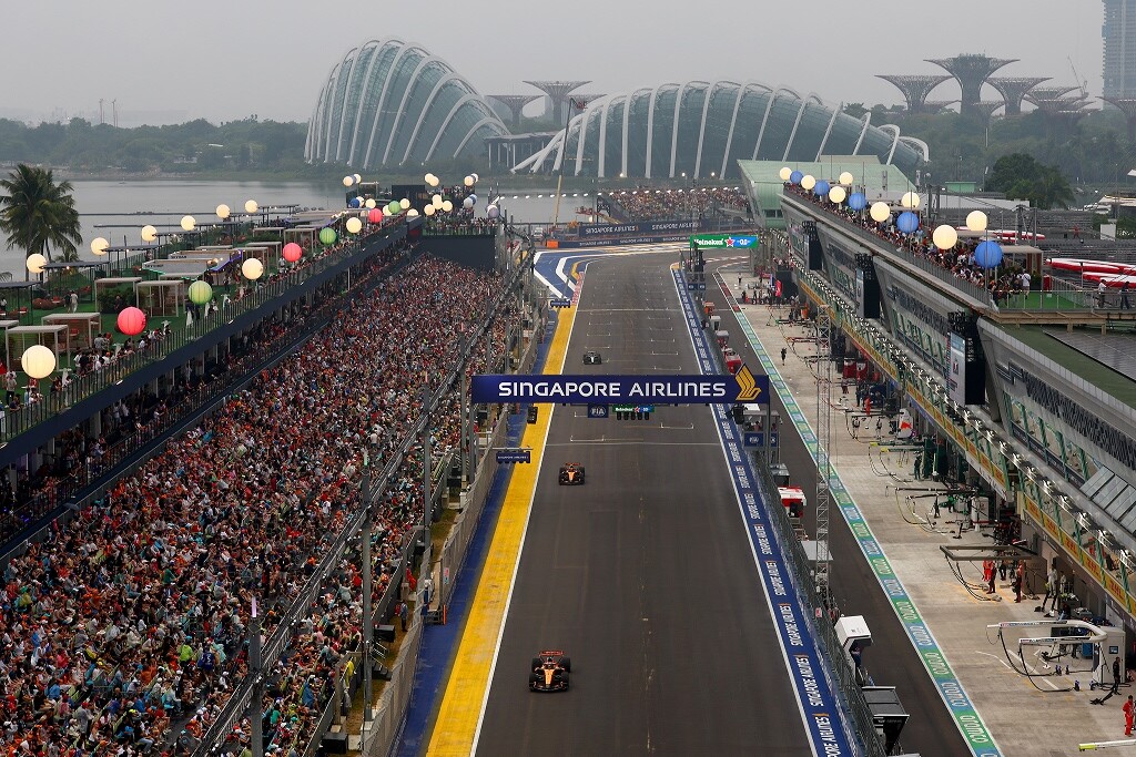 Packed grandstands along the Marina Bay Street Circuit straight with Gardens by the Bay behind