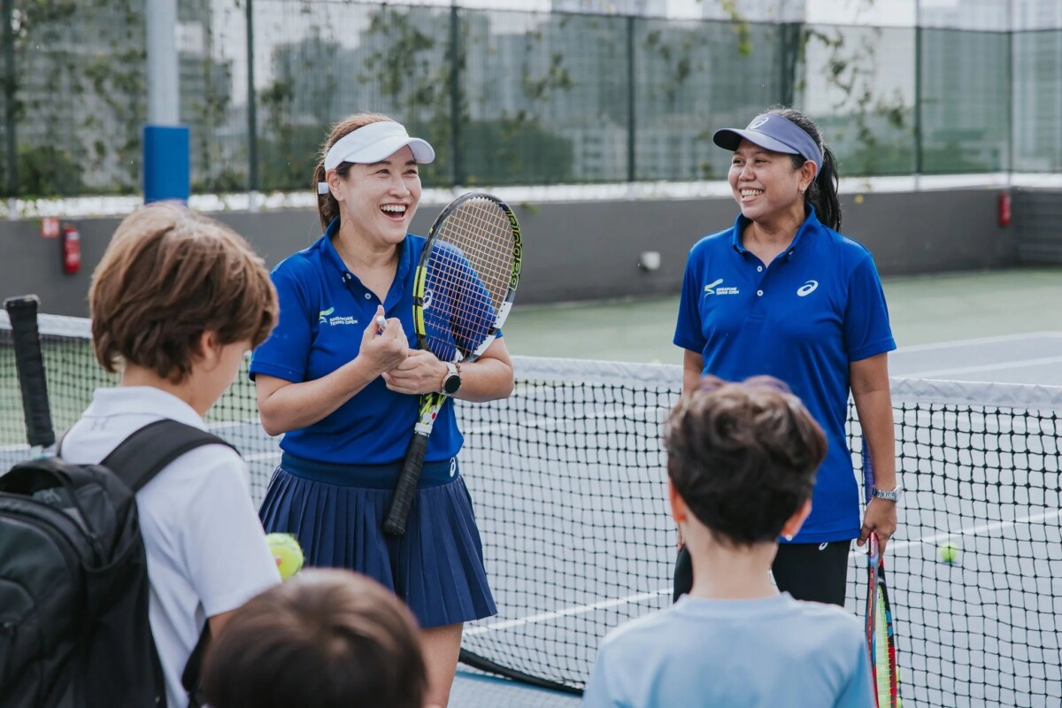 Singapore Tennis Open coaches and children on court during tournament activities at The Kallang
