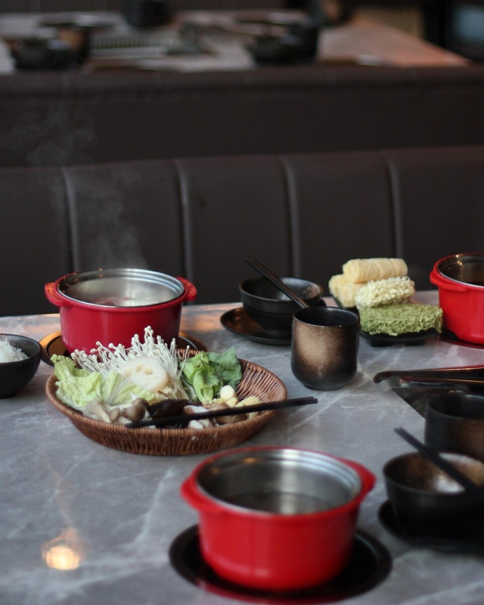 JING individual red hotpot with steam, vegetable basket and instant noodles at KINEX Mall Singapore