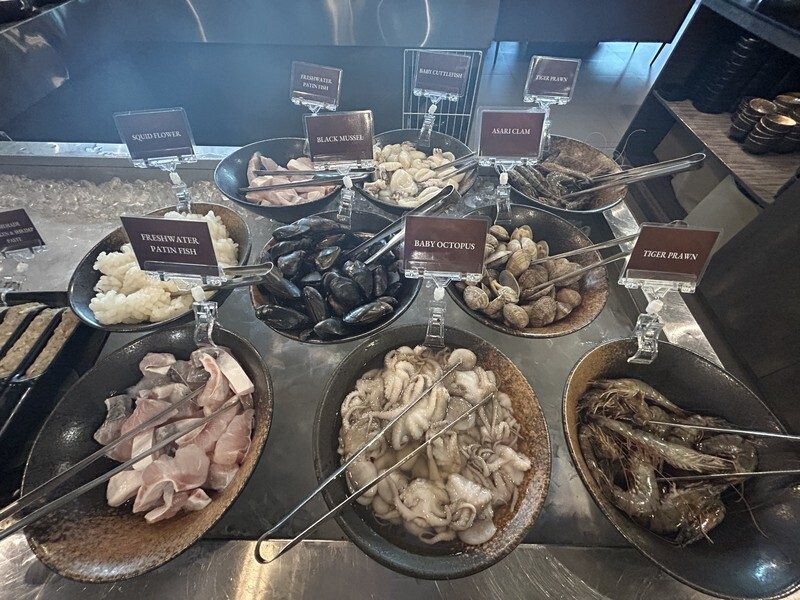 Fresh seafood selection of tiger prawns, asari clams, black mussels and baby octopus at JING
