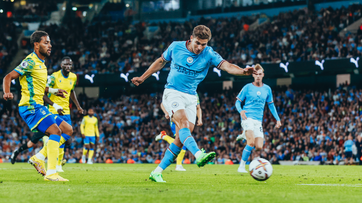 Julian Alvarez taking a shot for Manchester City during football match action