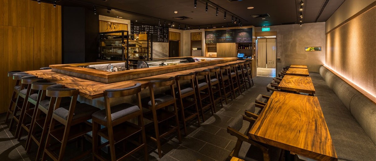 Koji Sushi Bar interior counter seating and sushi display at Raffles City