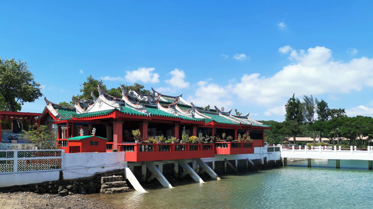 Red and green Chinese-style pavilion over the water on Kusu Island