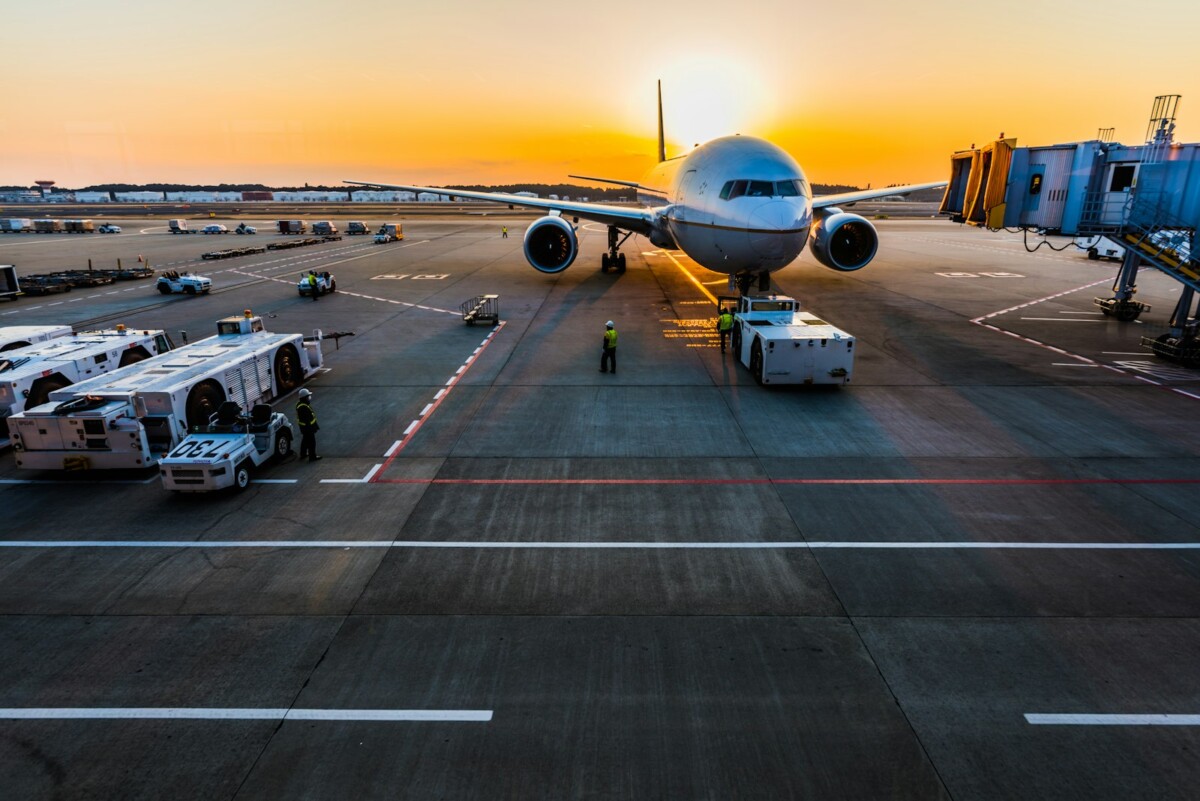 Passenger aircraft at the gate at sunset ready for departure