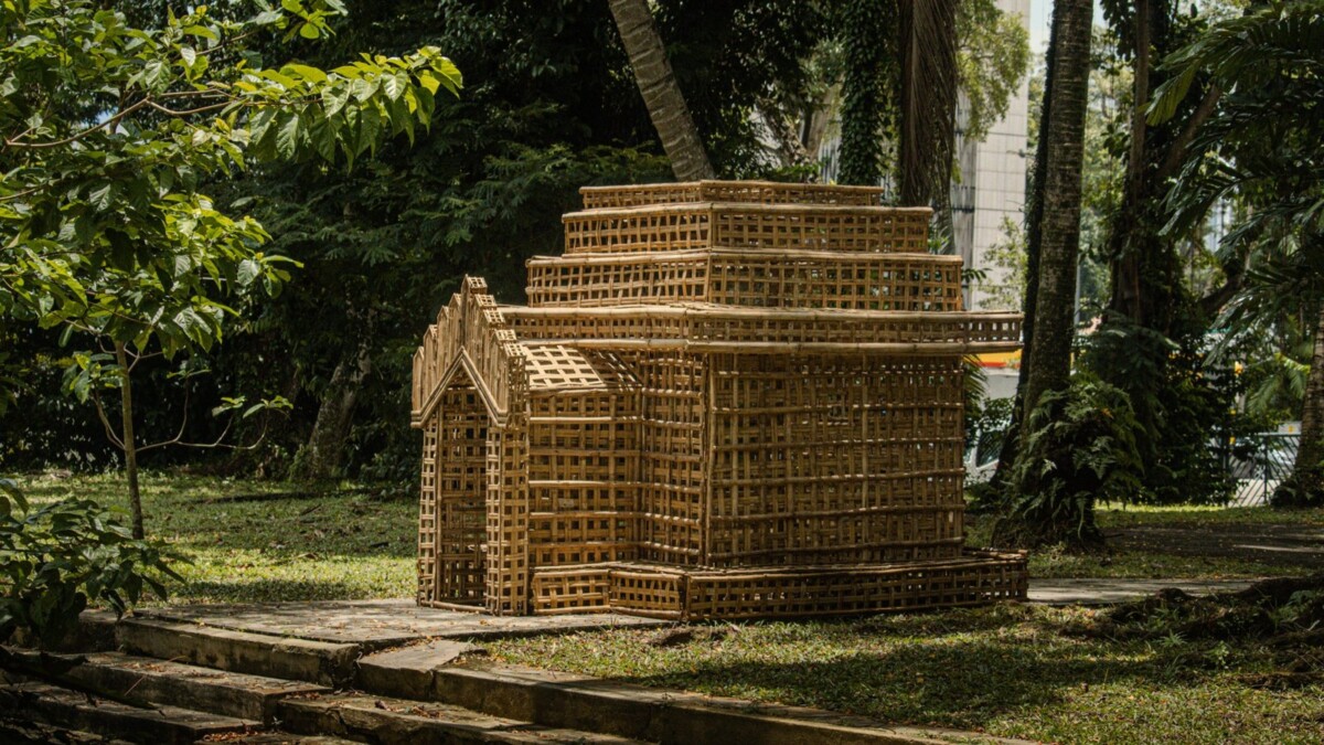 Woven lattice sculpture shaped like a house by Eindri Kyaw Sein on a lawn